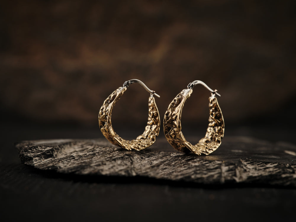 Textured brass earrings with silver sleeper clasp.