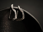 Earrings in textured silver and geometric shapes.