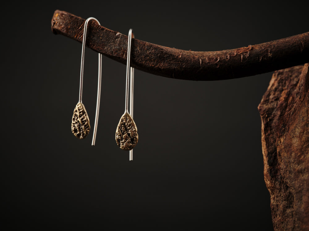 Ear hooks in brass and textured teardrop shape.