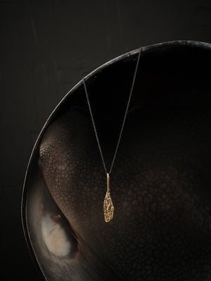 
                  
                    Upload image to gallery, Long, geometric and textured pendant made of brass suspended from an oxidized silver chain.
                  
                